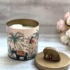 A handmade soy wax candle with natural fragrance oils, encapsulated in a reusable jar. The candle emits a warm, inviting glow as it burns, filling the room with a delightful scent.